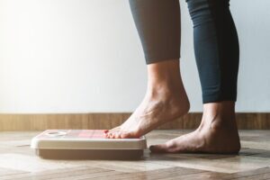 A close-up of a bathroom scale, symbolizing the potential weight changes associated with Prozac® use and highlighting the importance of a balanced diet and exercise in managing these effects.