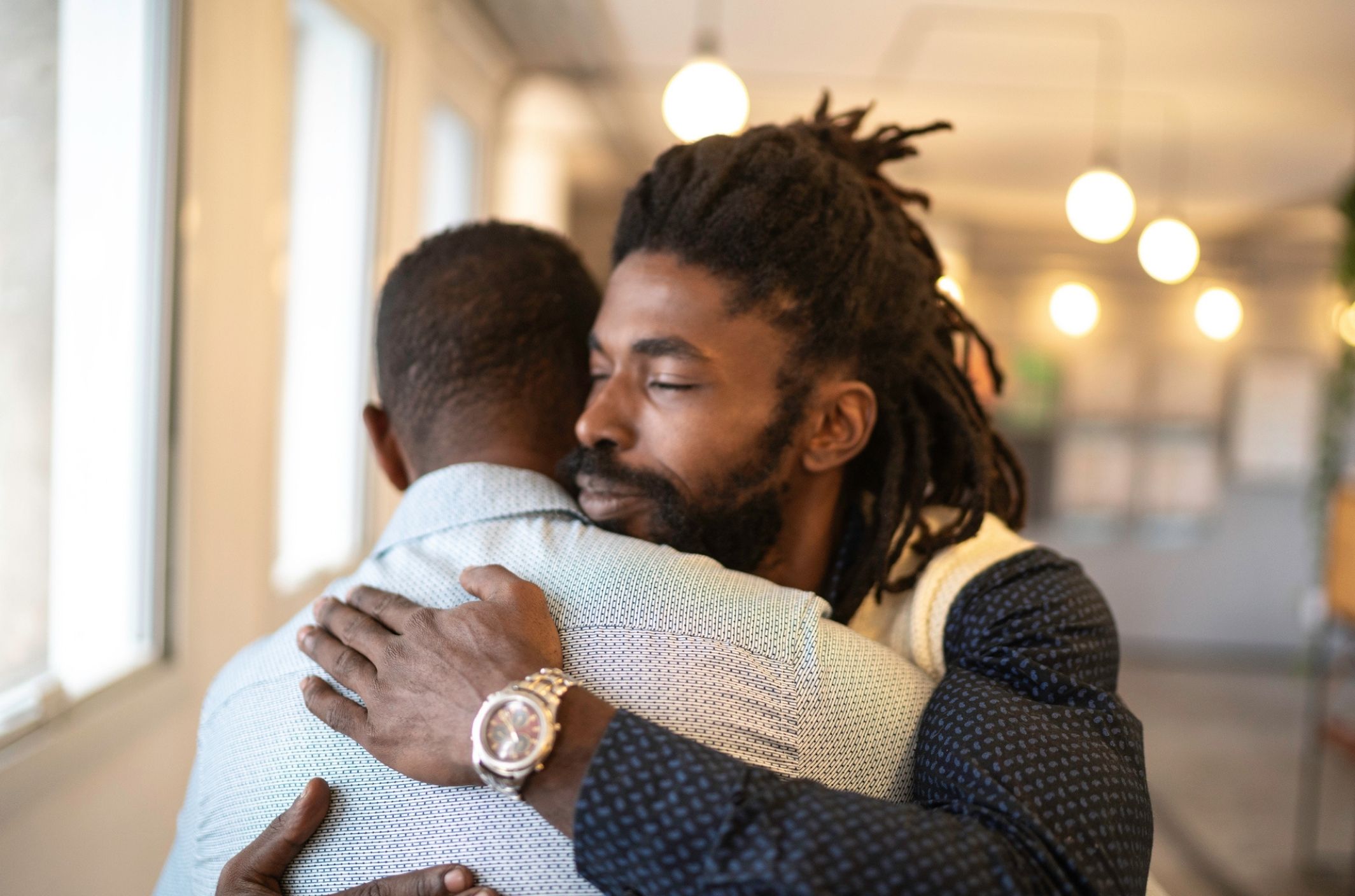 two friends hug after one learned what to say to help a depressed person