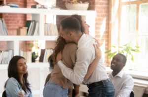 people hugging during recovery group showing that addiction is a disease