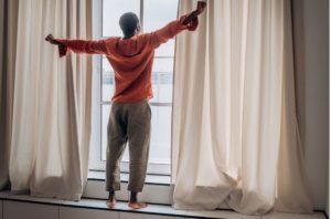man stretching good sleep after learning causes of insomnia