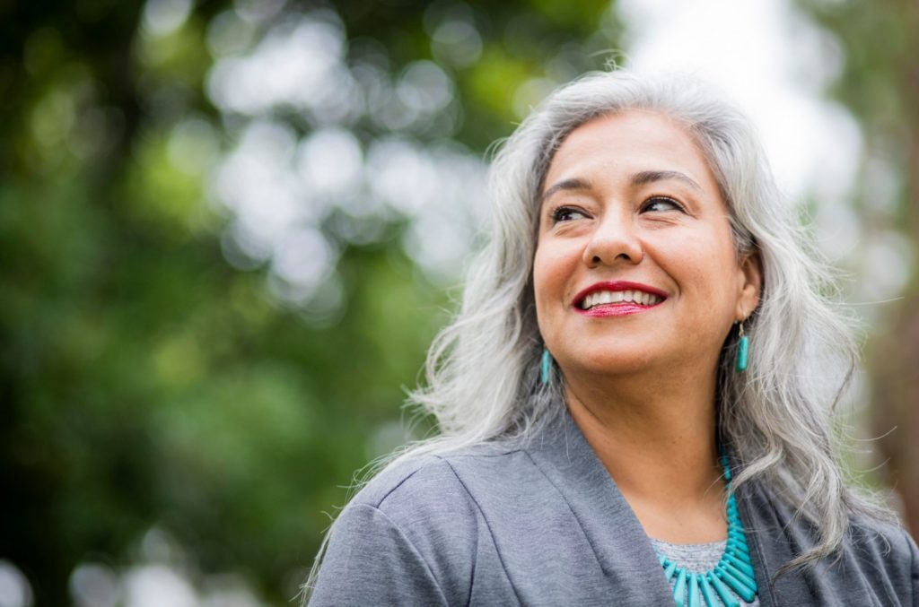 woman in park smiling after treatment for generalized anxiety disorder symptoms