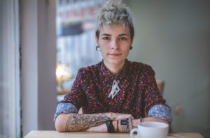 young woman tattoos practicing with negative self talk and inner critic